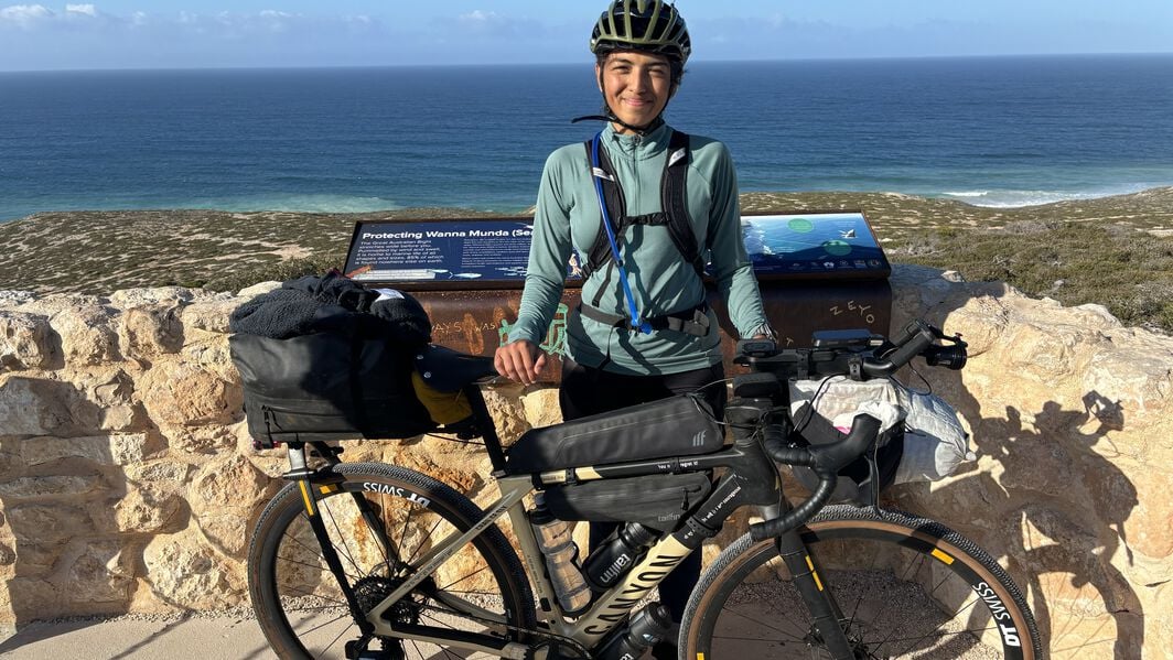 Things to Consider on How to Bikepacking on a Budget – Vedangi Kulkarni’s Expert Tips Vedangi Kulkarni with a fully loaded Canyon bikepacking setup near the coast, sharing tips on how to bikepack on a budget and travel smart